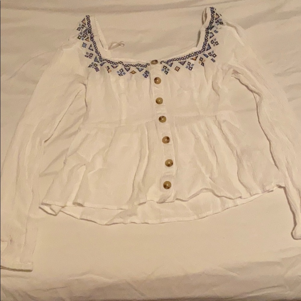 Embroidered white top.